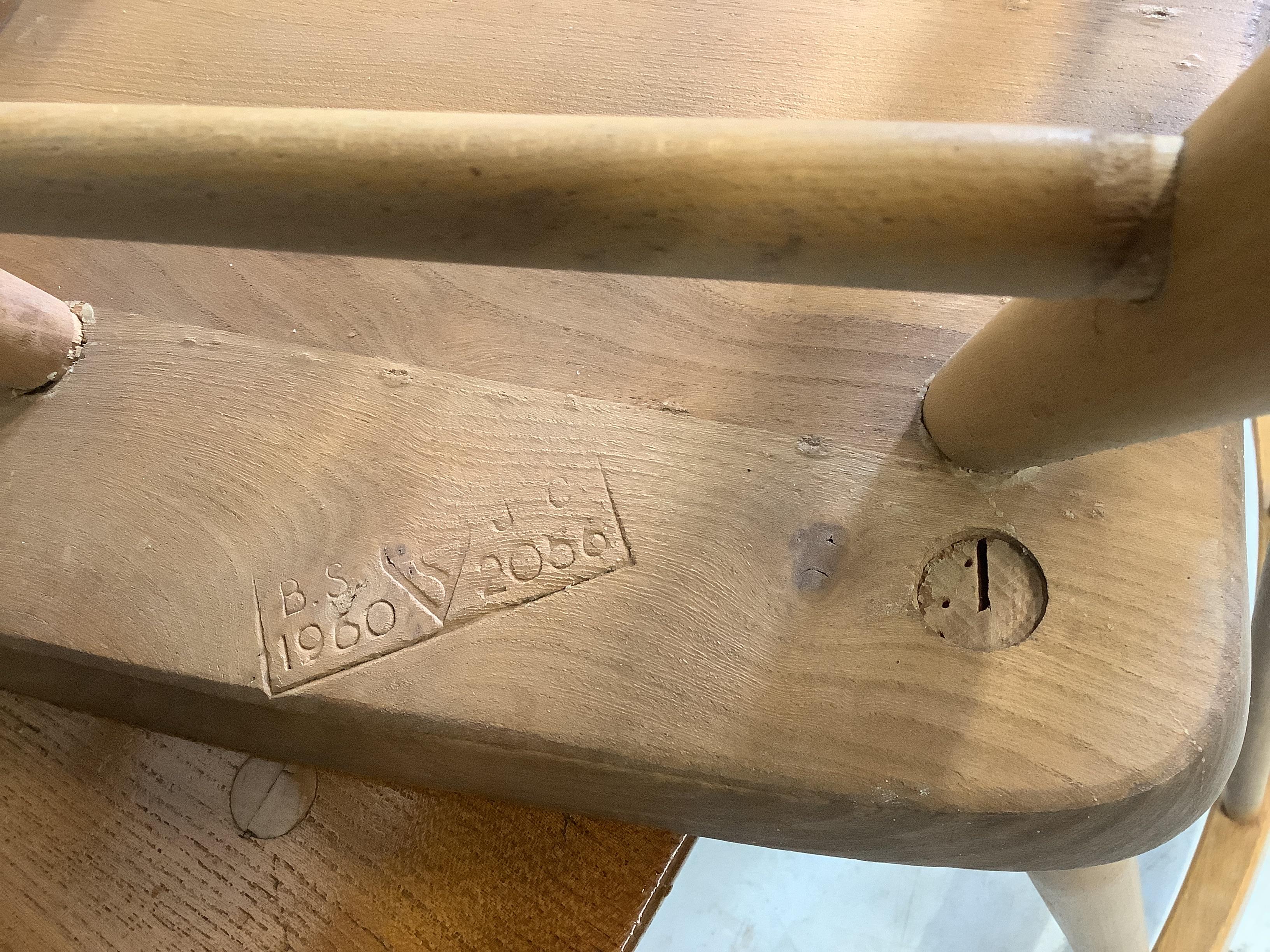 A set of four Ercol 391 elm and beech comb back dining chairs